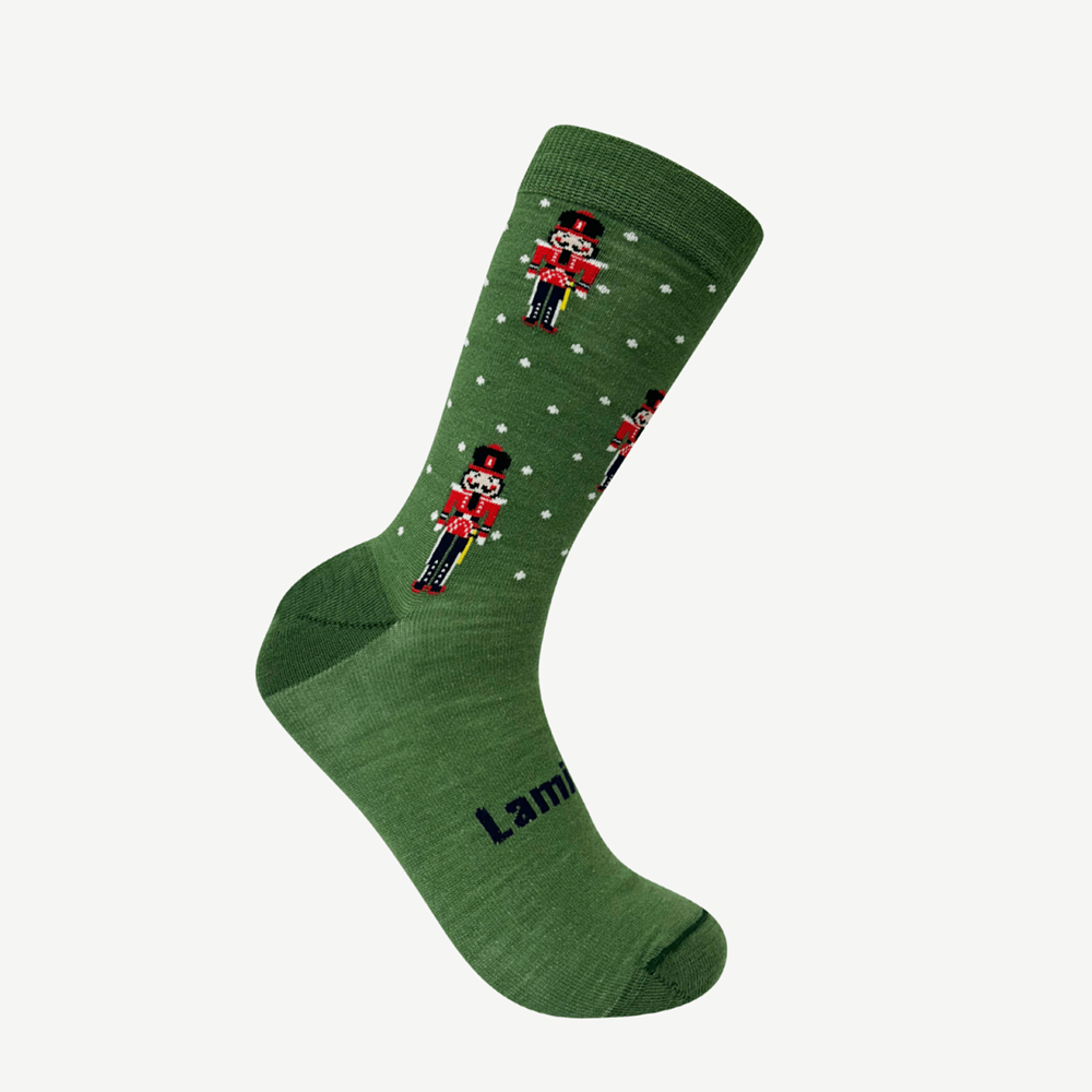 Green sock with white spots with nutcracker design