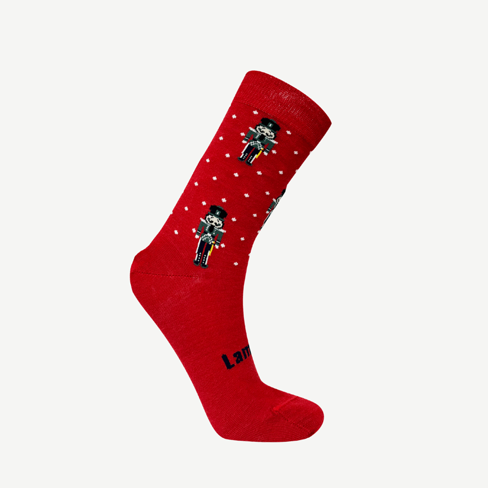 Red sock with white spots with nutcracker design